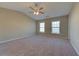 Spacious bedroom featuring neutral tones, two large windows, and a ceiling fan at 922 Gardenia Curv, Canton, GA 30114