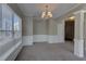 Spacious dining room with elegant wainscoting, chandelier, and ample natural light at 922 Gardenia Curv, Canton, GA 30114