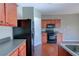 Well-equipped kitchen featuring dark appliances, laminate countertops, and wood cabinets at 922 Gardenia Curv, Canton, GA 30114