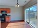 Eat-in kitchen with wood floors, wood cabinets and sliding door to the outside at 922 Gardenia Curv, Canton, GA 30114