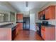 Functional kitchen with wood cabinets, laminate countertops, and modern black appliances at 922 Gardenia Curv, Canton, GA 30114