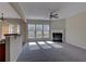 Sunlit living room featuring a cozy fireplace and large windows overlooking the backyard at 922 Gardenia Curv, Canton, GA 30114