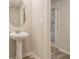 Elegant powder room featuring pedestal sink and modern fixtures at 11930 Guelph Cir, Hampton, GA 30228