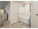 Bathroom with tub and shower, featuring neutral tile at 11930 Guelph Cir, Hampton, GA 30228