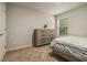 Bright bedroom with neutral carpet and a large dresser at 11930 Guelph Cir, Hampton, GA 30228