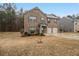 Two-story brick home featuring a spacious front yard with tasteful landscaping at 11930 Guelph Cir, Hampton, GA 30228