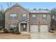 Charming brick home with a two-car garage and a well-maintained front yard at 11930 Guelph Cir, Hampton, GA 30228