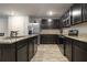 Modern kitchen with granite countertops, stainless steel appliances, and dark wood cabinets at 11930 Guelph Cir, Hampton, GA 30228