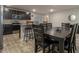Eat-in kitchen with modern stainless steel appliances, wood cabinets, and a dining table at 11930 Guelph Cir, Hampton, GA 30228