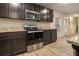 Well-equipped kitchen boasts wood cabinets, stainless steel appliances, and granite countertops at 11930 Guelph Cir, Hampton, GA 30228