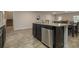 Kitchen island with a sink and dishwasher, connecting to the dining area and stairs at 11930 Guelph Cir, Hampton, GA 30228