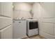 This laundry room features a new washer and dryer and wire shelving at 11930 Guelph Cir, Hampton, GA 30228