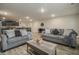 Open-concept living room showcases wood floors, sofas, and a view into the dining area at 11930 Guelph Cir, Hampton, GA 30228