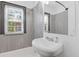 Bathroom featuring a white pedestal sink, gray tile surround, and a window for natural light at 2776 Grand Sw Ave, Atlanta, GA 30315