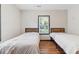 Bright bedroom with hardwood floors features two twin beds and a window offering natural light and neighborhood views at 2776 Grand Sw Ave, Atlanta, GA 30315