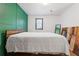 Comfortable bedroom featuring an accent wall, bright window, and stylish wood accents at 2776 Grand Sw Ave, Atlanta, GA 30315