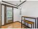 Dining area featuring wood-look flooring, bar-height table with stools, and a sliding barn door at 2776 Grand Sw Ave, Atlanta, GA 30315