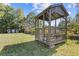 A charming gazebo with seating is nestled in a lush green backyard, offering a serene outdoor retreat at 2776 Grand Sw Ave, Atlanta, GA 30315