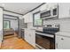 Bright kitchen with stainless appliances, white cabinets, subway tile backsplash, and wood-look flooring at 2776 Grand Sw Ave, Atlanta, GA 30315