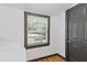Functional laundry room with white appliances, wood-look flooring and a window for natural light at 2776 Grand Sw Ave, Atlanta, GA 30315