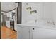 Convenient laundry area with modern appliances and shelving near a stylish renovated kitchen at 2776 Grand Sw Ave, Atlanta, GA 30315