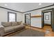 Bright living room featuring hardwood floors, a neutral sofa, and a view into the kitchen and bedroom at 2776 Grand Sw Ave, Atlanta, GA 30315