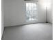 Bedroom with neutral walls and carpet, a large window, and minimalist decor at 5586 Kingsport Dr, Atlanta, GA 30342