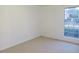 Inviting bedroom with neutral carpet and a window showcasing the outdoors at 5586 Kingsport Dr, Atlanta, GA 30342
