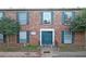 Brick apartment building featuring blue doors and shutters plus well-maintained landscaping at 5586 Kingsport Dr, Atlanta, GA 30342