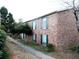 Exterior angle shot of apartment complex featuring brick facade, green shutters, and walkway at 5586 Kingsport Dr, Atlanta, GA 30342