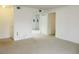 Open living room featuring neutral walls and carpet, flowing into the dining area at 5586 Kingsport Dr, Atlanta, GA 30342
