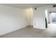 Bright living room with neutral walls and carpet, flowing into the kitchen and dining area at 5586 Kingsport Dr, Atlanta, GA 30342