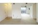 Living room with neutral walls and carpet, leading to the outdoor patio at 5586 Kingsport Dr, Atlanta, GA 30342