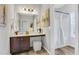 Well-lit bathroom with vanity, large mirror, and shower with curtain at 132 Cessna Dr, Canton, GA 30114