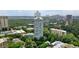 An aerial view of high rise apartments surrounded by lush green trees and beautiful city skyline in the background at 2870 Pharr Court South Nw # 2901, Atlanta, GA 30305