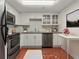 Efficient kitchen with stainless steel appliances, white cabinets, and uniquely patterned terracotta tile flooring at 2870 Pharr Court South Nw # 2901, Atlanta, GA 30305