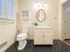 Bathroom featuring a vanity with storage, decorative mirror and patterned tile flooring at 3969 Briaridge Cir, Atlanta, GA 30340