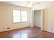 Bright bedroom features a ceiling fan, hardwood floors, and a closet with louvered doors at 3969 Briaridge Cir, Atlanta, GA 30340