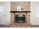 Detailed shot of a brick fireplace with mantle and decorative accessories, wood-style flooring at 3969 Briaridge Cir, Atlanta, GA 30340