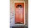 Close up of the vibrant orange front door with a decorative window and modern hardware at 3969 Briaridge Cir, Atlanta, GA 30340