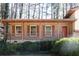 Cozy brick front porch with columns, railing, and charming windows, and orange front door at 3969 Briaridge Cir, Atlanta, GA 30340