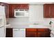 Spacious kitchen featuring white appliances and light countertops with wooden cabinetry at 3969 Briaridge Cir, Atlanta, GA 30340
