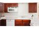 Bright kitchen featuring white appliances, wooden cabinets, and plenty of countertop space at 3969 Briaridge Cir, Atlanta, GA 30340