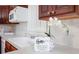 Close-up of a kitchen counter with faux flower accenting the white cabinetry at 3969 Briaridge Cir, Atlanta, GA 30340