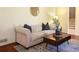 Comfortable living room with a plush sofa, modern coffee table, and staircase in the background at 3969 Briaridge Cir, Atlanta, GA 30340