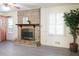 Living room featuring a brick fireplace, plantation shutters, and stylish decor at 3969 Briaridge Cir, Atlanta, GA 30340
