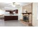Open-concept living space with a brick fireplace, wood floors, and view into the kitchen at 3969 Briaridge Cir, Atlanta, GA 30340