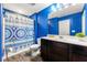 Stylish bathroom featuring modern fixtures, dark wood cabinets, and a shower-tub combination at 6380 Kennonbriar Ct, Lithonia, GA 30058