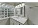 Bright bathroom with glass block window, sleek vanity with ample storage, and contemporary fixtures at 346 Carpenter Dr # 29, Atlanta, GA 30328