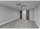Spacious bedroom featuring sleek gray flooring, a modern ceiling fan, and frosted glass closet doors at 346 Carpenter Dr # 29, Atlanta, GA 30328